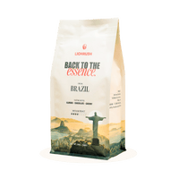 Coffee bag with 'Back to the Essence' branding and a scenic design on a white background