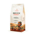 Coffee bag with 'Back to the Essence' branding and an illustration of a person wearing a colorful headscarf.