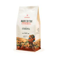 Coffee bag with 'Back to the Essence' branding and an illustration of a person wearing a colorful headscarf.