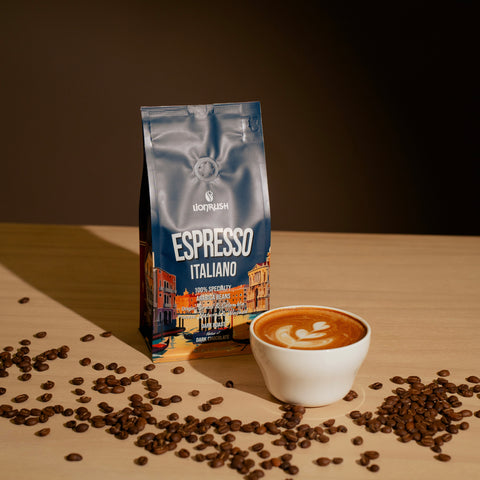 Espresso Italiano coffee bag with a cup of coffee and scattered beans on a wooden surface.