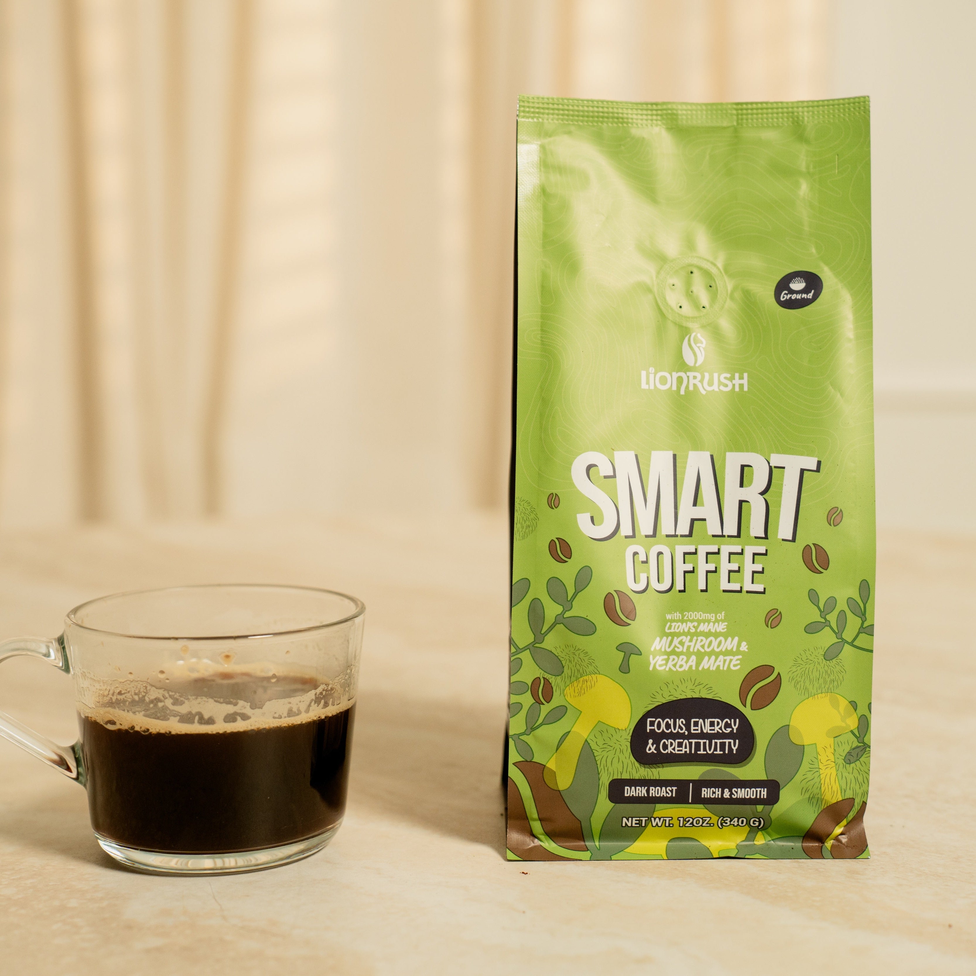 Green coffee bag labeled 'Smart Coffee' next to a glass of coffee on a wooden surface.